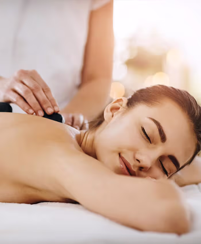 a client relaxing during a hot stone massage treatment